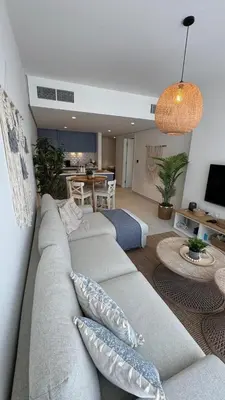 a living room with a gray couch with pillows at Ayla-Azure in Aqaba