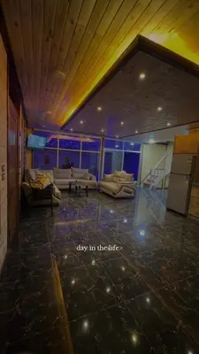 a living room with couches and a staircase at شاليه وكوخ البركه Albarakah chalets in Ajloun