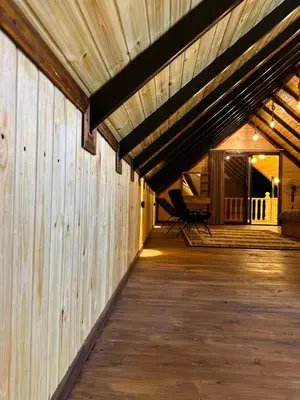 a large wooden building with a wooden deck at شاليه وكوخ البركه Albarakah chalets in Ajloun
