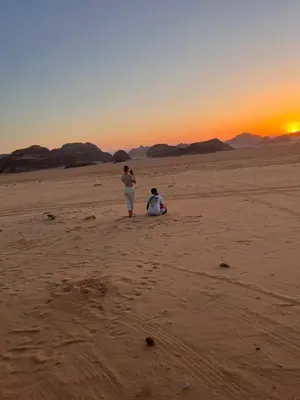 two people walking in the desert at sunset at LMA Rum Luxury Camp in Wadi Rum
