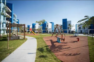 a park with swings and a playground at شقه شاطئيه in Aqaba