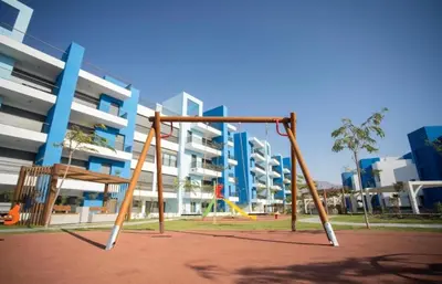 an empty playground in front of a large building at شقه شاطئيه in Aqaba
