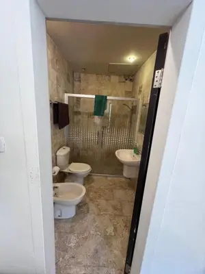 a bathroom with two toilets and a shower at Sossita Guesthouse & Boutique Resort