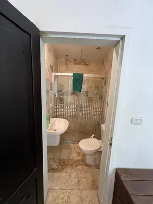 a bathroom with a toilet and a sink at Sossita Guesthouse & Boutique Resort