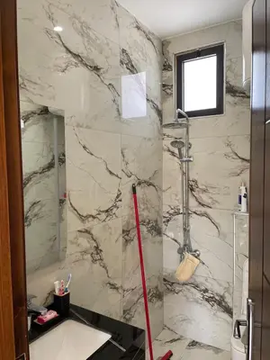 a bathroom with a marble shower and a sink at For Rent ,New Furnished Rooftop in Shafa Badran in Amman