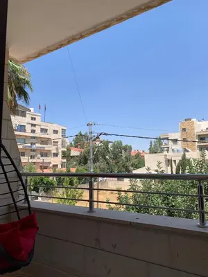 a balcony with a view of a city at Shmeisani Cozy Apartment in Amman