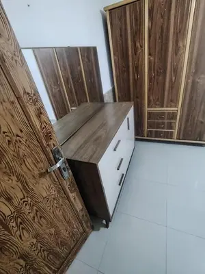 a kitchen with a wooden cabinet and a door at الشهم 10 in Irbid