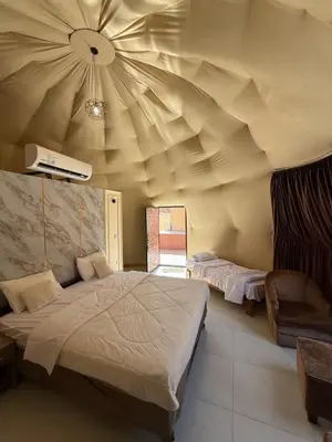 a room with two beds and a ceiling at Nala Luxury Camp & Bubbles Hotel in Wadi Rum