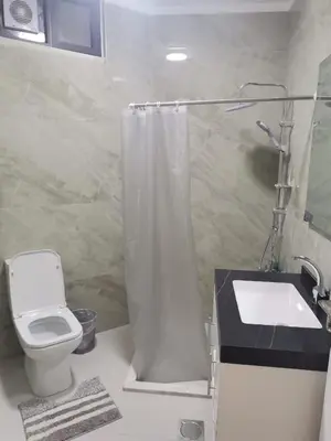 a bathroom with a toilet and a sink and a shower at 2 Master Bedroom Deluxe Apartment Queen Alia Airport Families Women ONLY in Amman