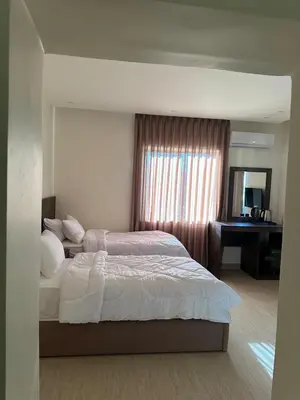 a bedroom with a bed and a desk and a mirror at Midtown Lweibdeh Hostel in Amman