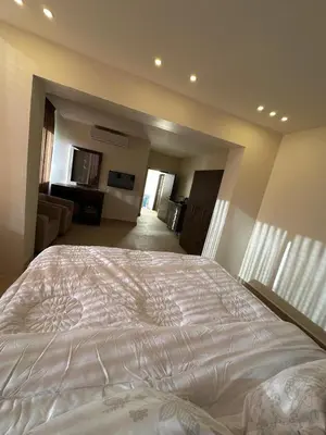 a bedroom with a large white bed in a room at Midtown Lweibdeh Hostel in Amman