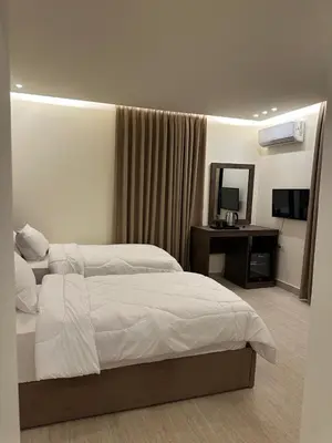 a bedroom with a bed and a desk and a mirror at Midtown Lweibdeh Hostel in Amman