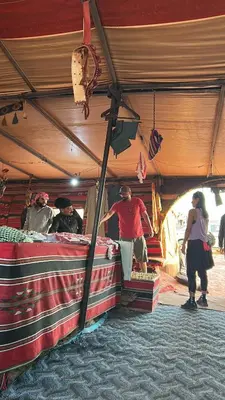 a group of people standing under a tent at Lamis Camp Wadi Rum in Aqaba