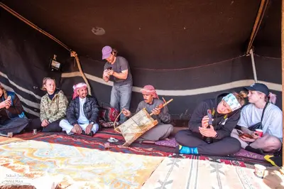 a group of people sitting in a tent at Stars Night Camp in Wadi Rum