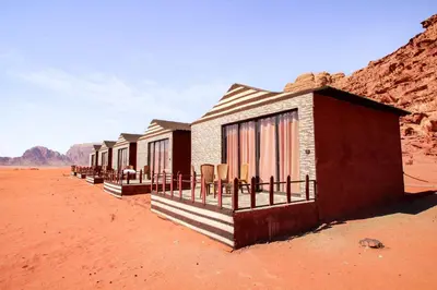 a row of buildings in the desert at Dune Camp Tours in Wadi Rum