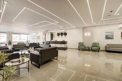 a lobby with couches and chairs and tables at aqaba hills hotel in Aqaba