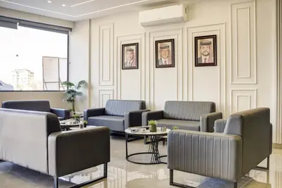 a waiting room with couches and tables at aqaba hills hotel in Aqaba