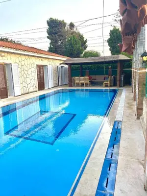 a swimming pool with blue water in a house at Yousef chalet in Amman