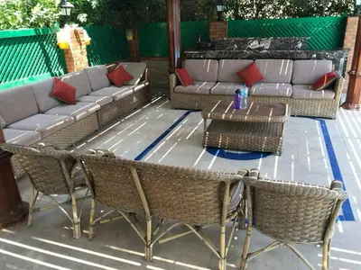 a patio with a couch and chairs and a table at Yousef chalet in Amman