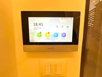 a computer screen on a wall with a clock at Brand New Stylish Luxe Apartment Near US Embassy Abdoun in Amman