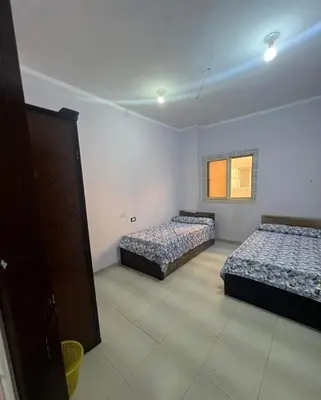 a bedroom with two beds and a window at Family house in Petra