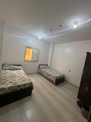 a room with two beds and a window at Family house in Petra