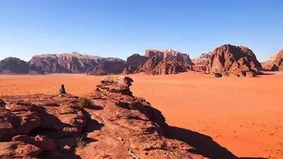 a person standing on top of a desert at Martian Desert Camp in Wadi Rum