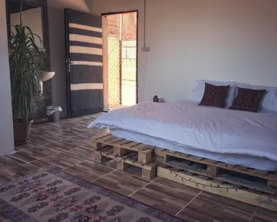 a bedroom with a bed made out of pallets at Martian Desert Camp in Wadi Rum