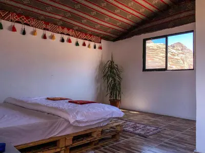 a bedroom with a bed in a room with a window at Martian Desert Camp in Wadi Rum