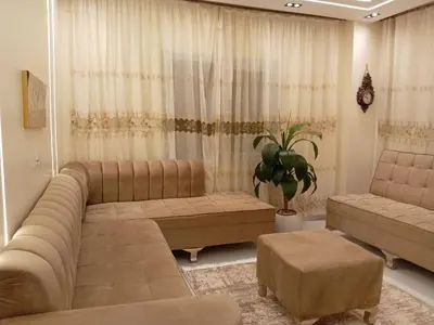 a living room with a large couch and a table at Samara inn in Aqaba