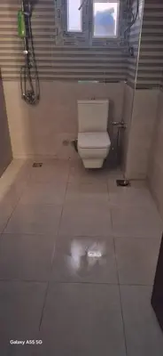a bathroom with a white toilet in a room at Samara inn in Aqaba