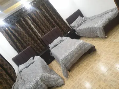 two twin beds in a room with at مزرعه الخال in Al Kafrayn