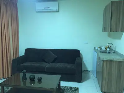 a living room with a couch and a table at Zaina Plaza Hotel in Amman