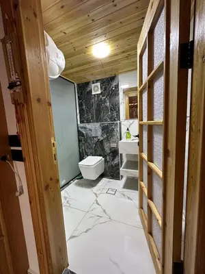 a bathroom with a toilet and a sink at أكواخ المها oryx cottage in Ajloun