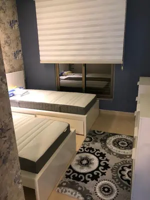 a small bedroom with two beds and a window at تقاطع الحرمين -خلف برجر كينج دوار الكيلو in Amman