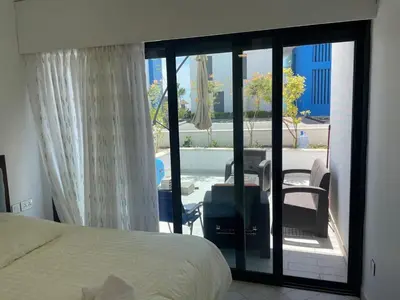 a bedroom with a bed and a view of a patio at العقبة in Aqaba