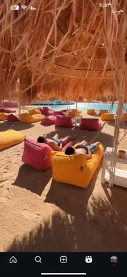 a group of people laying in kayaks on a beach at العقبة in Aqaba