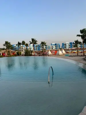 a swimming pool in the middle of a resort at One bedroom at ayla azure in Aqaba