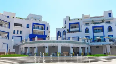 a large building with a fountain in front of it at Ayla Oasis Golf Apartment - Ayla Vista in Aqaba