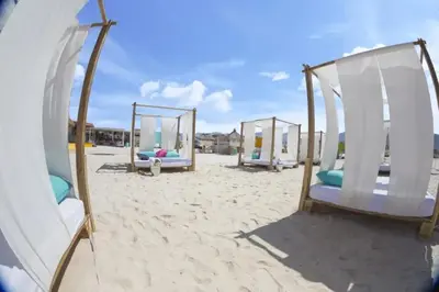 a row of tents on a sandy beach at Ayla Oasis Golf Apartment - Ayla Vista in Aqaba