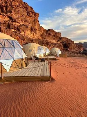 a group of tents sitting in the desert at وادي رم مخيم in Wadi Rum