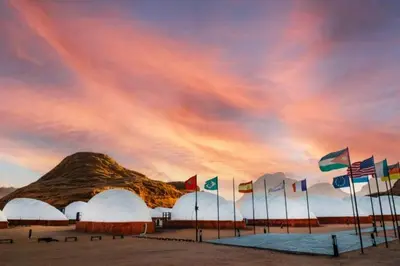 a group of flags in front of a mountain at Luxury Spiral Camp in Maḩaţţat Dīsah