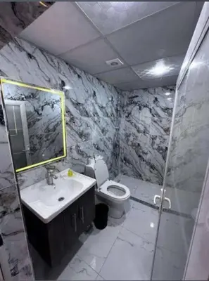 a bathroom with a toilet and a sink and a shower at Luxury Spiral Camp in Maḩaţţat Dīsah