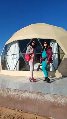 two women standing in front of a dome at RUM iSLAND bubble LUXURU CAMP in Wadi Rum