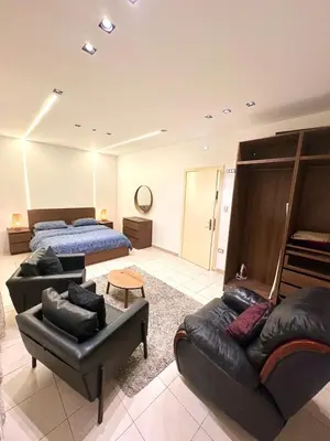 a living room with two beds and a couch at Abdoun Modern Apartment Near US Embassy in Amman