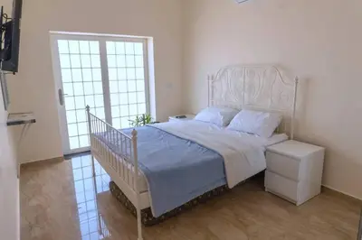 a bedroom with a bed with a blue comforter at Private villa with pool in Deadsea Jordan in Al Rama