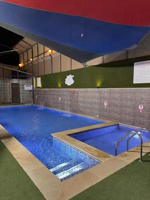a large swimming pool with blue water in a building at Private villa with pool in Deadsea Jordan in Al Rama