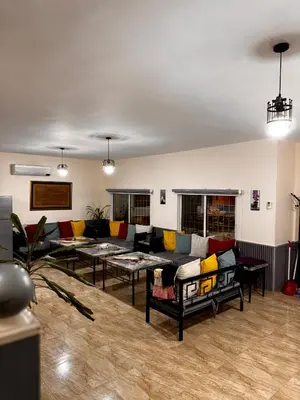 a living room with couches and tables at Private villa with pool in Deadsea Jordan in Al Rama