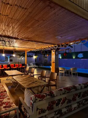 a restaurant with tables and chairs and a bar at Private villa with pool in Deadsea Jordan in Al Rama