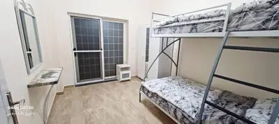 a bedroom with two bunk beds and a window at Private villa with pool in Deadsea Jordan in Al Rama